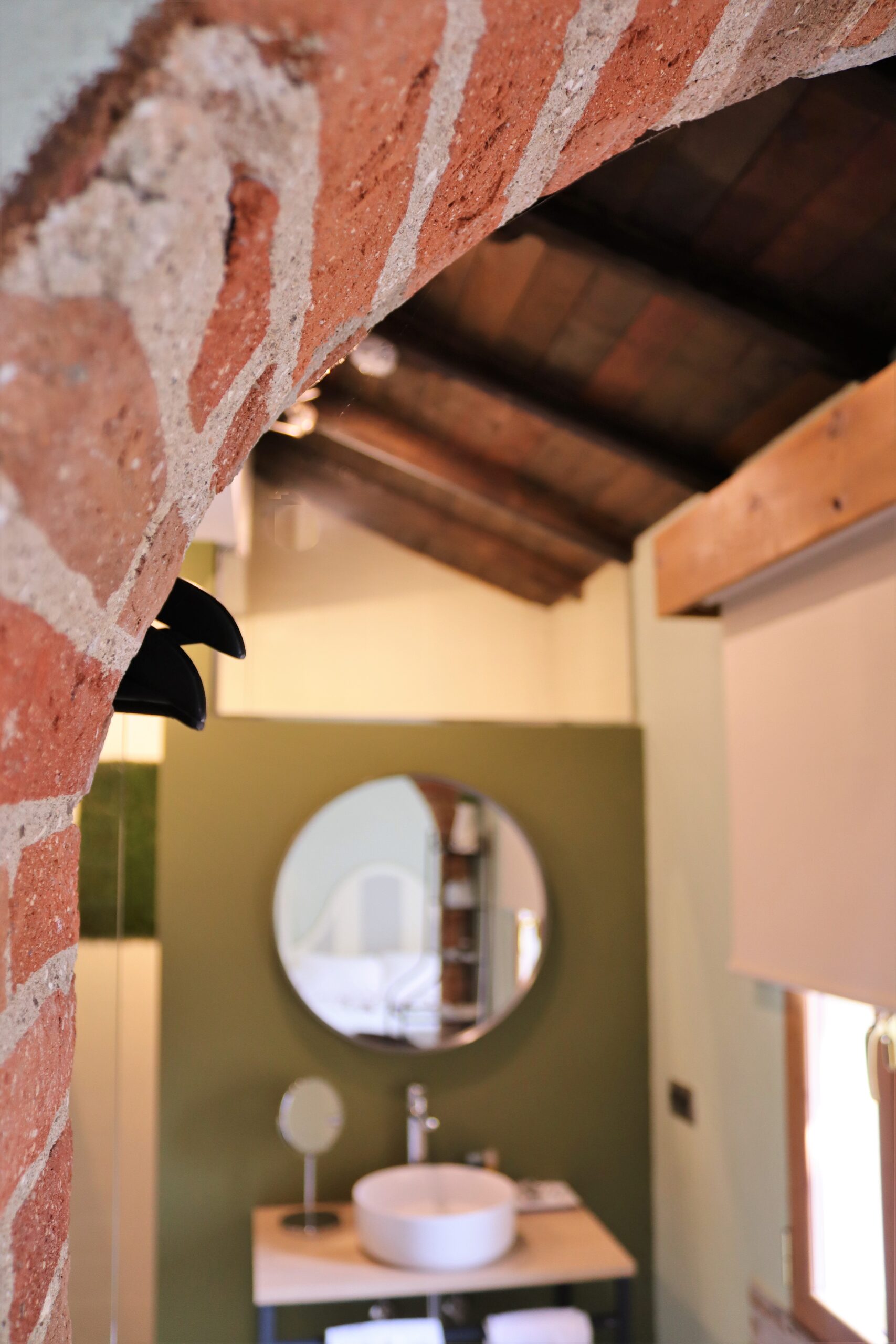 Detalle de arco de ladrillo y baño en Suite El Bosque